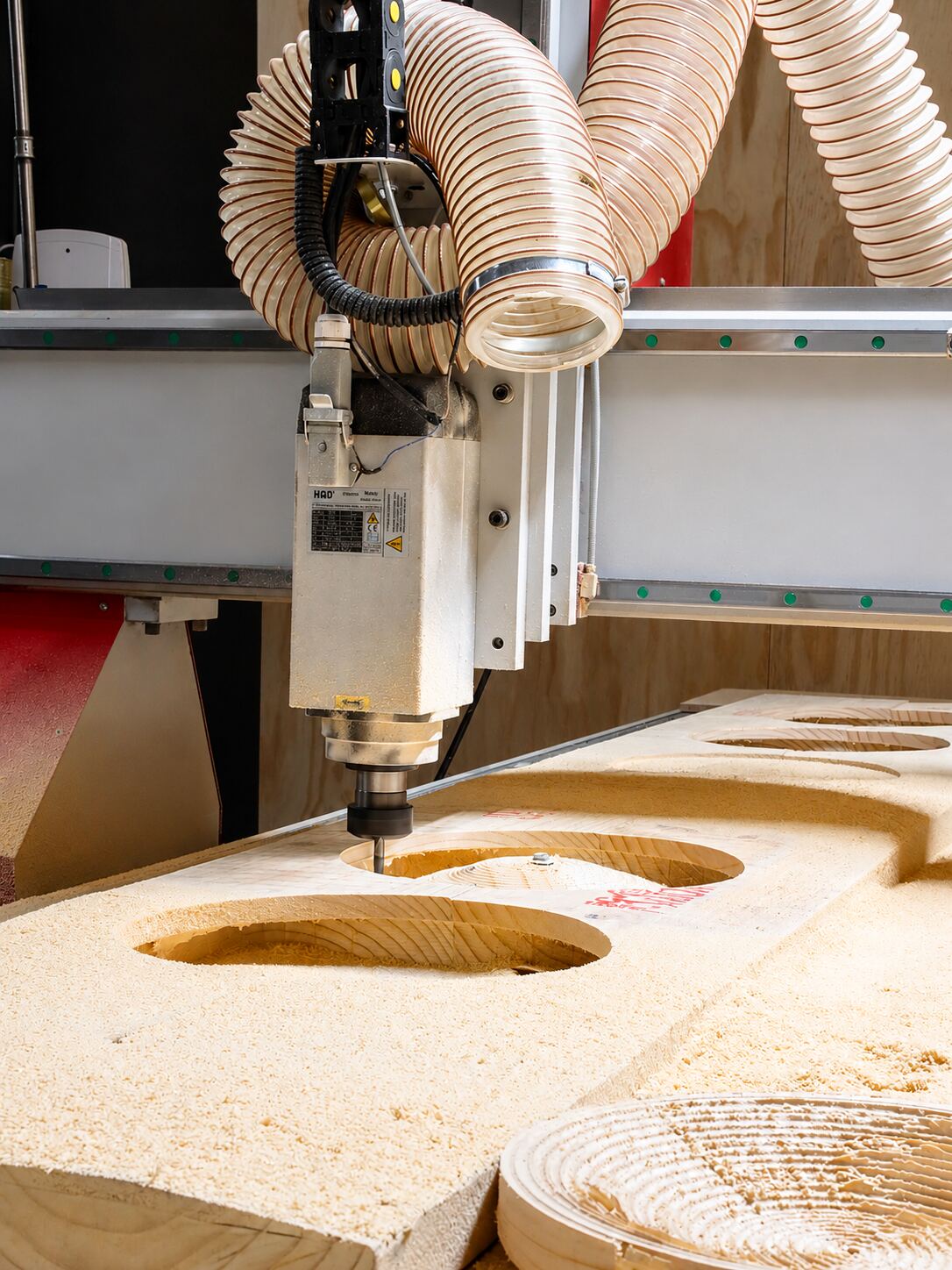 CNC router cutting a curved timber lighting component in the Streamlight workshop