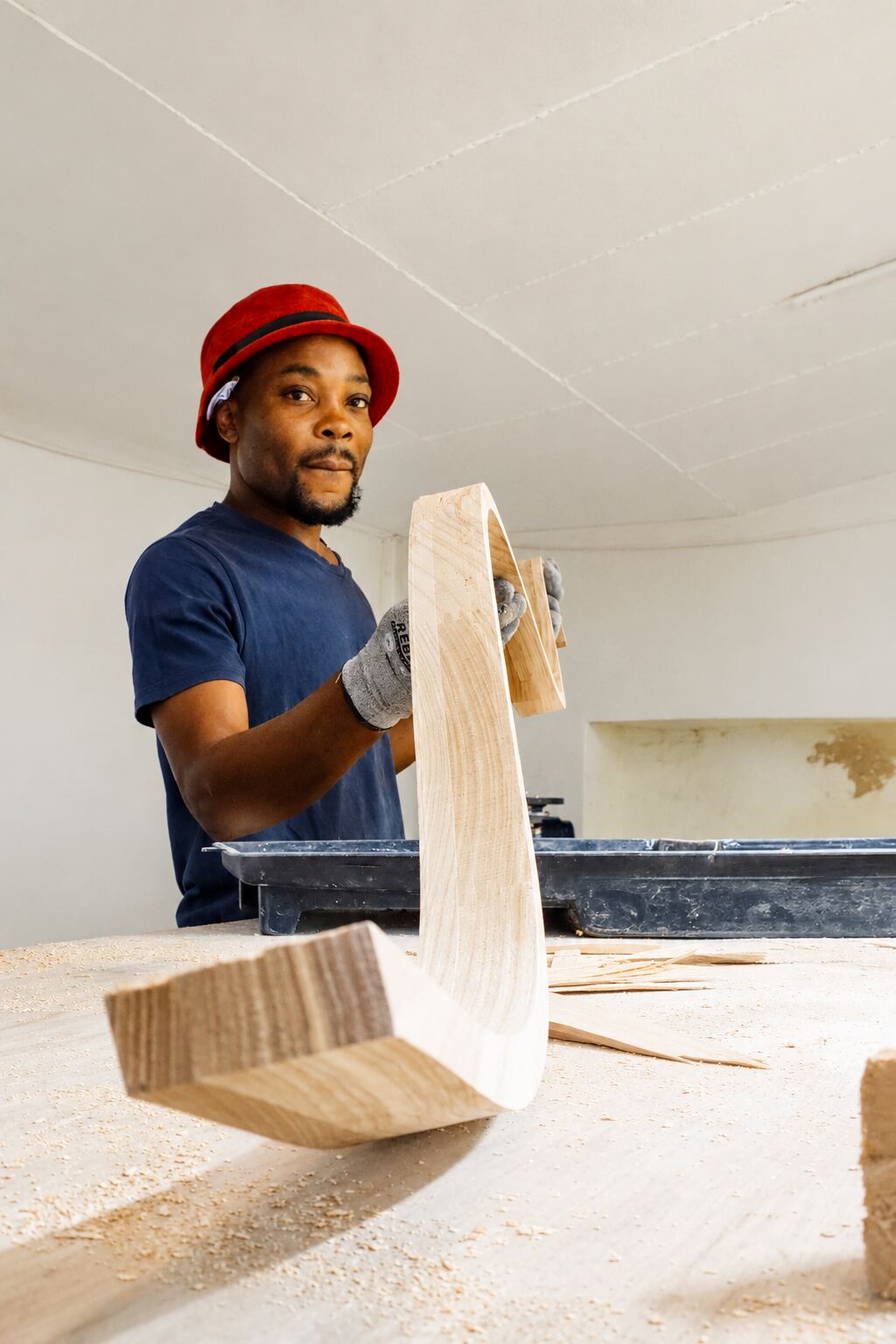 Streamlight craftsman inspecting a curved timber fixture component after machining