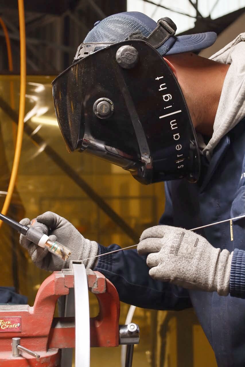 Streamlight fabricator TIG welding an aluminium fixture profile in the Kramerville factory