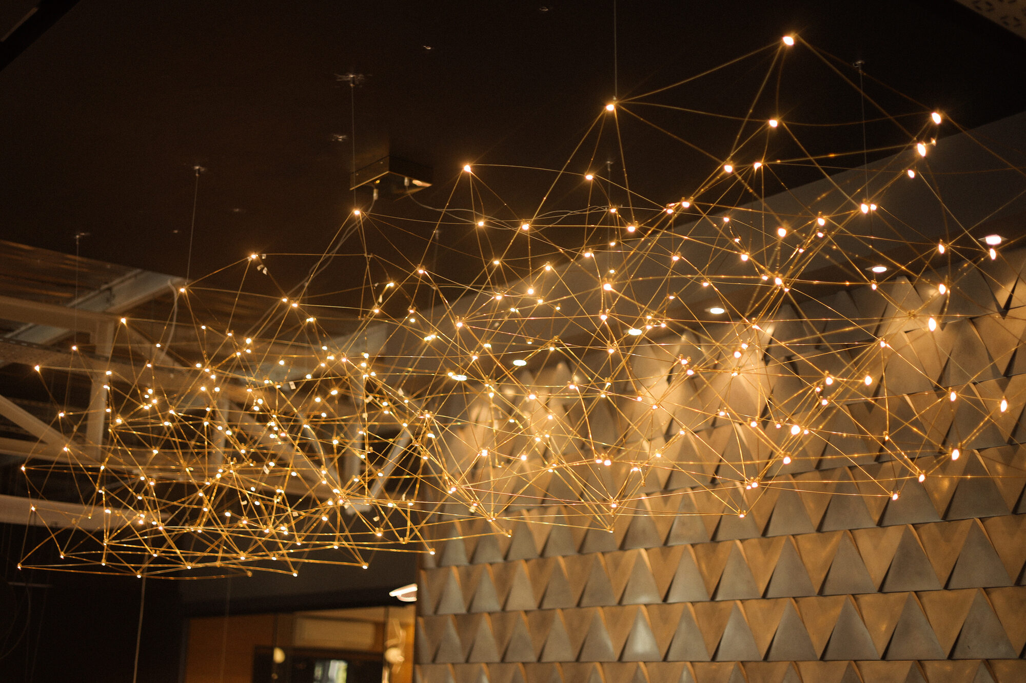 Large sculptural constellation-style ceiling light installation in a hospitality venue, custom lighting by Streamlight